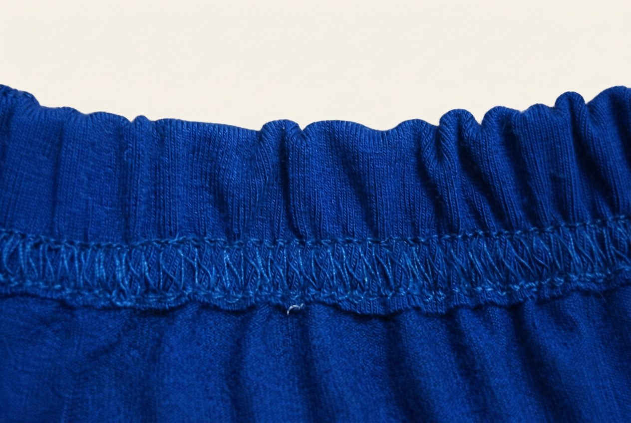 Dusty blue Comfy Kids Co toddler pants laid flat showing the soft elastic waistband and minimal seams
