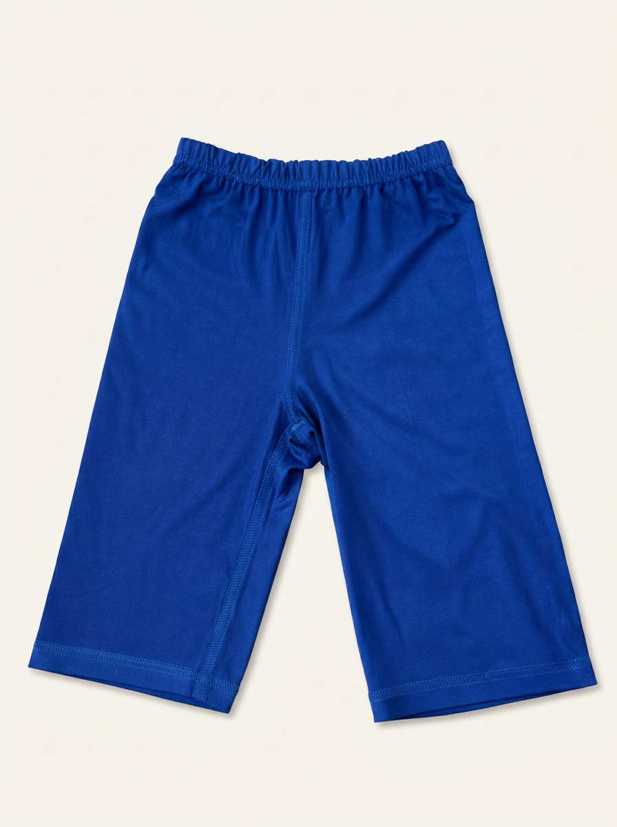 Folded cobalt blue Comfy Kids Co toddler pants on a warm ivory background